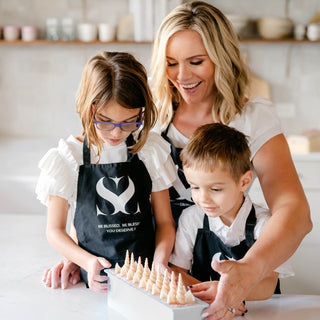 Founder of Blissed Botanical Co, Erin and her family in the kitchen making cold process soaps