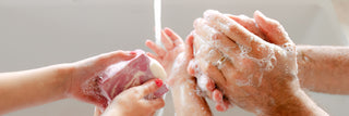 Family washing hands together, making bubbles, using cold process soaps