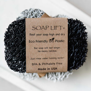 Eco Friendly Bio Plastic Black and Gray Soap Lifts resting on a bathroom countertop